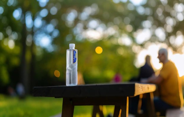 Dew Drop bottle on a park table