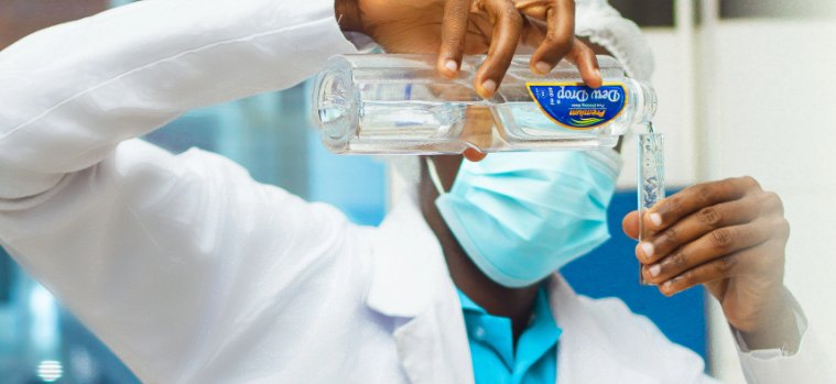 Dew Drop laboratory technician testing a water sample